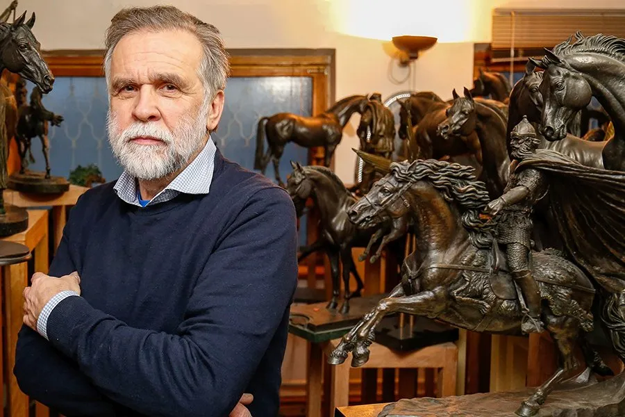 Sergey Bondarenko in his studio, surrounded by his bronze horse sculptures